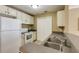 Compact kitchen with essential appliances, laminate counters, and a double basin sink at 1101 Juniper St # 61, Atlanta, GA 30309