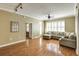 Bright living room featuring hardwood floors, ceiling fan, and a large sectional couch at 1101 Juniper St # 61, Atlanta, GA 30309