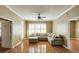 Bright living room featuring hardwood floors, large windows with plantation shutters, and comfortable sectional sofa at 1101 Juniper St # 61, Atlanta, GA 30309