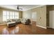 Hardwood floors in living room with large windows and neutral sectional sofa at 1101 Juniper St # 61, Atlanta, GA 30309