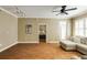 Comfortable living room with hardwood floors, neutral tones, and access to a bedroom at 1101 Juniper St # 61, Atlanta, GA 30309