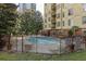 Outdoor pool surrounded by a black metal fence and lounge chairs, ideal for relaxation at 1101 Juniper St # 61, Atlanta, GA 30309