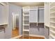 A walk-in closet has built-in shelving, providing ample storage space and organization for clothing and accessories at 1101 Juniper St # 61, Atlanta, GA 30309