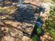 Aerial view of roof and yard with debris surrounded by mature trees at 3150 Old Van Wert Rd, Villa Rica, GA 30180