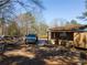 Exterior shot of the house with a vehicle parked in the yard, surrounded by trees at 3150 Old Van Wert Rd, Villa Rica, GA 30180