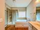 Relaxing bathroom with separate tub and shower, tiled floors, and a large window for natural light at 3780 Baxley Pine Trl, Suwanee, GA 30024