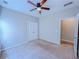 Bedroom features a ceiling fan and adjoining hallway or closet at 3780 Baxley Pine Trl, Suwanee, GA 30024