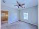 Bright bedroom featuring neutral carpet, ceiling fan, and a large window, creating a peaceful living space at 3780 Baxley Pine Trl, Suwanee, GA 30024
