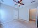 A clean and well-lit bedroom with a ceiling fan and an open door at 3780 Baxley Pine Trl, Suwanee, GA 30024