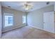 A cozy bedroom with natural light streaming through the windows, featuring a ceiling fan at 3780 Baxley Pine Trl, Suwanee, GA 30024