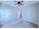 Bedroom with ceiling fan, carpet, and a double-door closet for optimal storage at 3780 Baxley Pine Trl, Suwanee, GA 30024