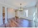 Elegant dining room with hardwood floors, columns, and a chandelier at 3780 Baxley Pine Trl, Suwanee, GA 30024