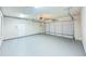 Spacious two car garage with epoxy flooring and ample lighting at 3780 Baxley Pine Trl, Suwanee, GA 30024