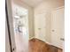 Hallway view with hardwood flooring, neutral paint and access to the kitchen at 3780 Baxley Pine Trl, Suwanee, GA 30024