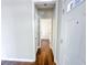 Hallway with hardwood floors leading to a bathroom; notice fresh paint and a clean appearance at 3780 Baxley Pine Trl, Suwanee, GA 30024