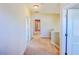 Upstairs hallway featuring neutral carpet and paint with doors leading to rooms at 3780 Baxley Pine Trl, Suwanee, GA 30024