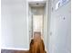 Bright hallway with hardwood flooring leading to the bathroom at 3780 Baxley Pine Trl, Suwanee, GA 30024