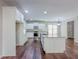 This kitchen has a center island, stainless appliances, and white cabinets at 3780 Baxley Pine Trl, Suwanee, GA 30024