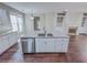 Bright, open kitchen featuring a large center island, stainless steel appliances, and granite countertops at 3780 Baxley Pine Trl, Suwanee, GA 30024