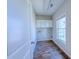 Bright laundry room featuring wood-look tile floors, white cabinets, and natural light at 3780 Baxley Pine Trl, Suwanee, GA 30024