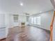 Bright living room with hardwood floors, fireplace, built-ins, and large windows at 3780 Baxley Pine Trl, Suwanee, GA 30024