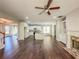 Open concept living room with wood floors and an open view into the modern kitchen at 3780 Baxley Pine Trl, Suwanee, GA 30024