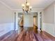 Bright living room featuring hardwood floors, columns, large trim and a decorative chandelier at 3780 Baxley Pine Trl, Suwanee, GA 30024
