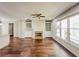 Spacious living room features a fireplace, built-in shelving, hardwood floors, and lots of natural light at 3780 Baxley Pine Trl, Suwanee, GA 30024