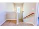 Staircase with carpet runner, white railing and natural lighting from the window at 3780 Baxley Pine Trl, Suwanee, GA 30024