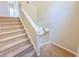 Carpeted staircase with white painted banister at 3780 Baxley Pine Trl, Suwanee, GA 30024