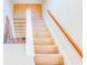 Carpeted stairs with a white and wood railing leading to a different floor at 3780 Baxley Pine Trl, Suwanee, GA 30024