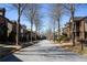 Wide street view of homes set back from the road, lined with trees at 3780 Baxley Pine Trl, Suwanee, GA 30024