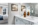 Well-lit primary bathroom with double sinks, modern fixtures, and a view into the bedroom at 5845 Schelton Se Pl, Mableton, GA 30126