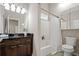 Modern bathroom with granite countertop vanity and shower with tub and toilet at 735 Ponce De Leon Ne Pl, Atlanta, GA 30306