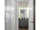 Bathroom features a modern vanity with a granite countertop, stylish lighting, and a view into another room at 735 Ponce De Leon Ne Pl, Atlanta, GA 30306