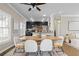 Bright dining area featuring modern table, chairs, rug and view into kitchen and living room with sofa at 735 Ponce De Leon Ne Pl, Atlanta, GA 30306