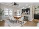 Bright dining area featuring modern table, chairs, rug and view into kitchen with granite counters and stainless appliances at 735 Ponce De Leon Ne Pl, Atlanta, GA 30306