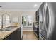 Bright kitchen featuring stainless steel appliances, granite countertops, gray cabinets and a modern sink at 735 Ponce De Leon Ne Pl, Atlanta, GA 30306