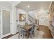 Dining room with a rustic wood wall, a modern table set, and staircase view at 1892 Braeburn Se Cir, Atlanta, GA 30316