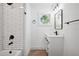 Modern bathroom with tub and shower and a round window at 2423 Melinda Ne Dr, Atlanta, GA 30345