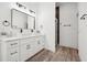 Sleek bathroom with double vanity, modern mirrors, and glass-enclosed shower for a spa-like experience at 2423 Melinda Ne Dr, Atlanta, GA 30345