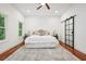 Bright bedroom featuring a ceiling fan, wood floors, and a barn door leading to closet at 2423 Melinda Ne Dr, Atlanta, GA 30345