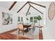 Sunlit dining room featuring vaulted ceilings, wooden beams, and hardwood flooring at 2423 Melinda Ne Dr, Atlanta, GA 30345
