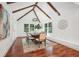 Vaulted dining area showcases wood beams, ample natural light, and a modern chandelier at 2423 Melinda Ne Dr, Atlanta, GA 30345