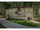 An inviting two-story home with modern black accents and a well-manicured lawn stands among mature trees at 2423 Melinda Ne Dr, Atlanta, GA 30345