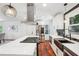 Updated kitchen features stainless steel appliances, island gas cooktop, and modern lighting at 2423 Melinda Ne Dr, Atlanta, GA 30345