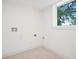 Clean laundry room space featuring a window and white walls at 2423 Melinda Ne Dr, Atlanta, GA 30345
