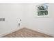 Bright laundry room with wood-look tile floors and a window providing natural light at 2423 Melinda Ne Dr, Atlanta, GA 30345