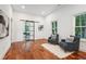 Comfortable sitting room featuring wood floors, soft rug and barn door leading to dining room at 2423 Melinda Ne Dr, Atlanta, GA 30345
