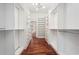 Bright, spacious walk-in closet with custom shelving and hardwood floors leading into the bedroom at 2423 Melinda Ne Dr, Atlanta, GA 30345